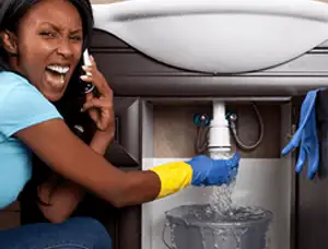 Emergency plumbing repair for a leaking sink drain under a bathroom vanity in Dayton, OH